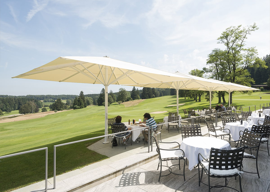 Large fixed parasol umbrellas for shading commercial golf clubs