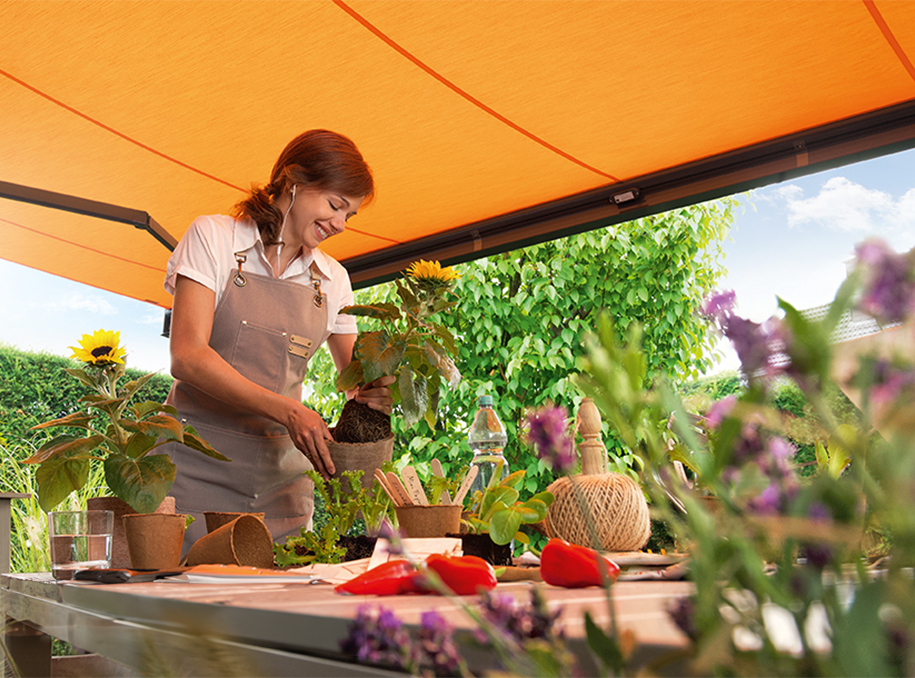 weinor awning yellow with lady gardening domestic home with automatic awning